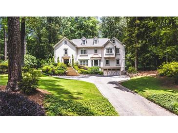 Stunning two-story home with lush landscaping, manicured lawn, and inviting driveway at 1165 E Beechwood Nw Dr, Atlanta, GA 30327