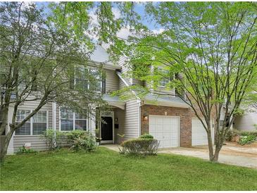 Charming two-story home with well-maintained lawn and attached two car garage, nestled among mature trees at 63 Fulton Se St, Atlanta, GA 30312