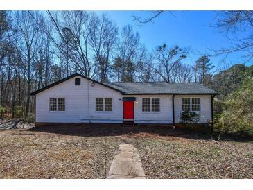 Charming single-story home with a vibrant red front door and a well-maintained yard at 160 Pine Grove Dr, Canton, GA 30114