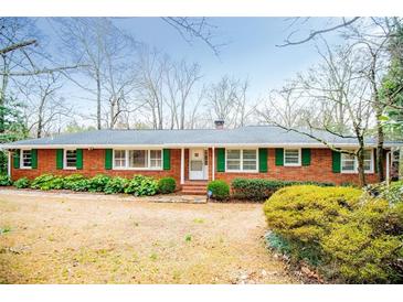 Charming brick ranch-style home with well-maintained landscaping and green shutters at 2191 Sweetwater Ln, Austell, GA 30106