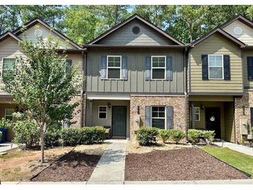 Charming townhome features a mix of stone and siding, complemented by well-maintained landscaping at 4221 Shoals Ln, Union City, GA 30291