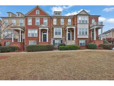Charming townhomes featuring brick facades, manicured landscaping, and inviting front entrances at 4874 Seldon Se Way, Smyrna, GA 30080