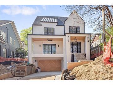 Striking two-story modern home with a covered porch, distinctive black-framed windows, and a convenient two-car garage at 555 Orme Ne Cir, Atlanta, GA 30306