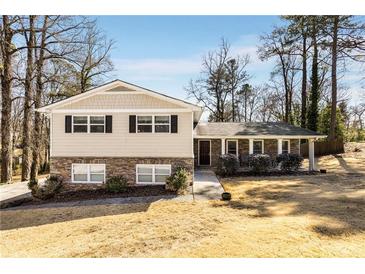 Charming home with a combination of stone and siding exterior, complemented by well-manicured landscaping at 2941 Foothill Trl, Marietta, GA 30066