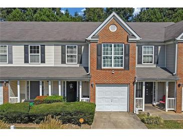 Charming townhome with brick accents, well-maintained landscaping, and an attached one car garage at 7158 Georges Way, Morrow, GA 30260