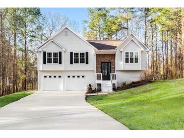 Charming split-level home featuring a two-car garage and manicured lawn on a lush lot at 88 Summer Lake Pl, Dallas, GA 30157