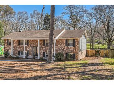 Charming brick home featuring classic shutters and a well-maintained yard at 3045 Riviera Nw Dr, Conyers, GA 30012
