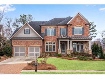 Elegant brick home with a well-manicured lawn and a two-car garage at 4850 Kentwood Dr, Marietta, GA 30068