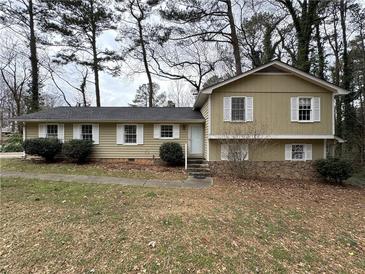 Charming split-level home with light yellow siding, white trim, and a well-maintained front yard at 2717 Rosemont Dr, Lawrenceville, GA 30044
