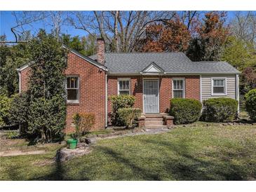 Charming brick home featuring a well-manicured lawn and cozy front entrance at 3542 W Hill St, Clarkston, GA 30021