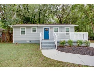 Charming single-story home featuring a blue front door, white trim, and manicured landscaping at 2598 Elliott Nw St, Atlanta, GA 30318
