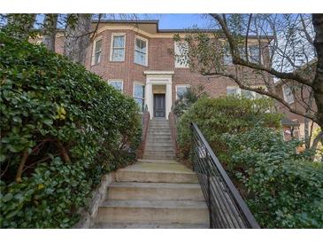 Charming brick townhouse with an inviting stairway entrance, lovely landscaping, and an attractive facade at 189 Westminster Dr, Atlanta, GA 30309