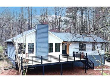 Charming home with a spacious deck and attractive architectural details at 137 Creekview Dr, Woodstock, GA 30188