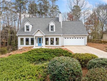 Charming home with a well-maintained front yard, dormer windows and an attached two car garage at 4240 Parnell Rd, Marietta, GA 30062