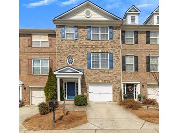 Charming brick townhome with blue shutters, a white garage, and well-maintained landscaping at 1868 Appaloosa Mill Ct, Buford, GA 30519