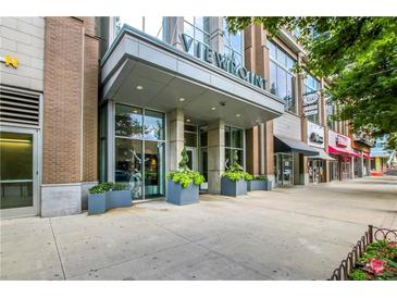 Viewpoint building entrance with planters and large windows in a thriving city center at 855 Peachtree Ne St # 2912, Atlanta, GA 30308