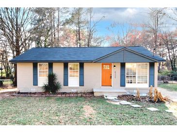 Charming brick home featuring blue shutters, a new roof, and a bright orange front door at 8325 Attleboro Dr, Jonesboro, GA 30238
