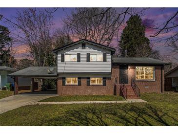 Charming two-story home with brick and siding exterior, plus a convenient covered carport at 2128 Jones Nw Rd, Atlanta, GA 30318