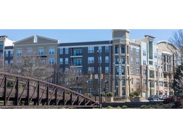 Beautiful exterior view of an apartment building with balconies and pedestrian bridge at 390 17Th Nw St # 2025, Atlanta, GA 30363