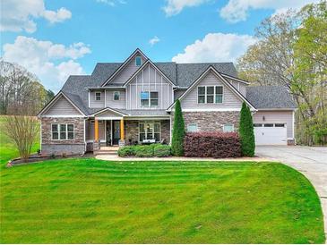 Beautiful two-story home featuring stone accents and a well-manicured lawn at 4539 Tiffany Ln, Loganville, GA 30052