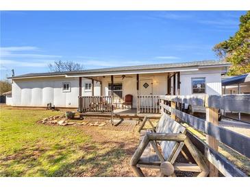 Charming single-story home with a cozy front porch and well-maintained lawn at 8989 E Cherokee Dr, Canton, GA 30115