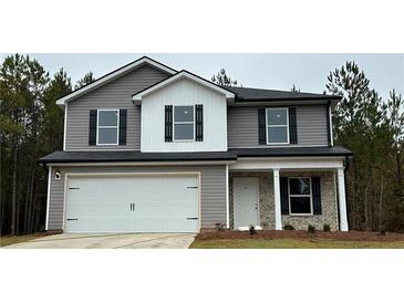 Charming two-story home with gray siding and a two-car garage in a serene, wooded setting at 108 Deer Xing, Temple, GA 30179