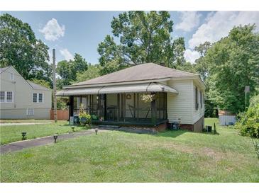 Charming home featuring a cozy, screened-in front porch perfect for enjoying the outdoors at 1742 Ware Ave, Atlanta, GA 30344