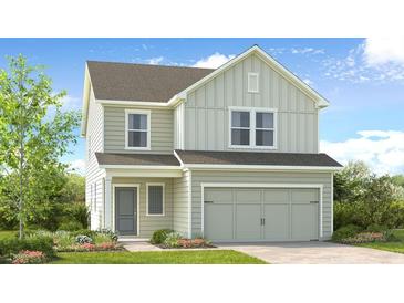 Charming two-story home with a gray exterior, attached two-car garage, and a beautifully landscaped front yard at 227 Groveton Ct, Euharlee, GA 30145