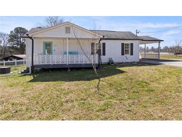 Charming single-story home with white siding and a cozy front porch at 3384 Nebo Rd, Dallas, GA 30157