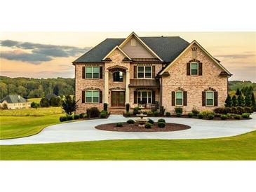 Stately brick home with manicured lawn, circular driveway, and fountain at 641 Freeman Brock Rd, Auburn, GA 30011