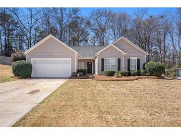 Charming single-story home with a well-manicured lawn and an attached two-car garage at 441 Concord Cir, Mcdonough, GA 30253