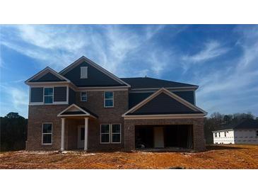 Two story brick home with black shutters under a blue sky at 3191 Morris Hills Dr, Dacula, GA 30019