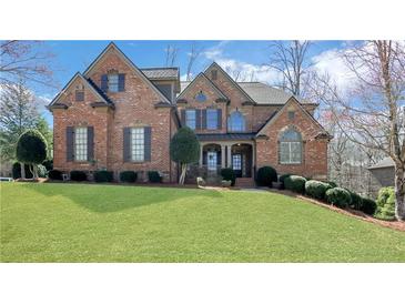 Stately brick home with manicured lawn and inviting front porch at 3493 Maryhill Nw Ln, Kennesaw, GA 30152