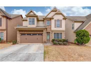 Charming two-story home featuring a brick and siding facade, well-manicured landscaping, and an attached two-car garage at 2479 Brynfield Cv, Suwanee, GA 30024