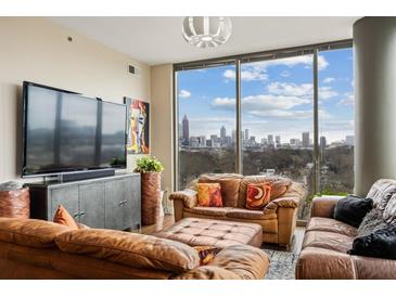 Inviting living room featuring brown leather furniture and expansive windows with skyline views at 270 17Th Nw St # 1113, Atlanta, GA 30363