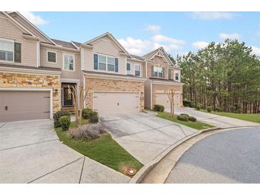 Beautiful townhomes with brick and siding, and well-manicured lawns at 5975 Vista Brook Dr, Suwanee, GA 30024