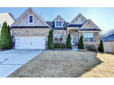 Charming two-story home featuring a manicured lawn, attached two car garage and a welcoming front porch at 1431 Torrington Dr, Auburn, GA 30011