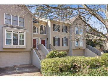 Attractive townhome featuring neutral colors, multi-pane windows, and a well-maintained lawn and landscaping at 2515 Oak Quarters, Smyrna, GA 30080