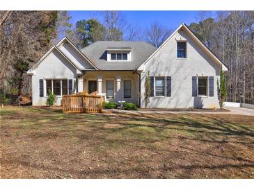 Charming single-story home featuring a welcoming front porch and a well-maintained yard at 1027 Holland Rd, Dallas, GA 30157