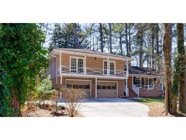 Charming home featuring a two-car garage and a second-story balcony for enjoying outdoor views at 1618 Cheryl Leigh Dr, Riverdale, GA 30296