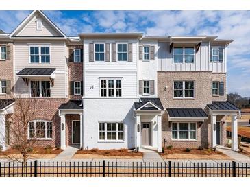 Beautiful townhome with black accents, neutral colored brick, and light colored siding with lovely curb appeal at 4826 Floydwood Ln, Mableton, GA 30126