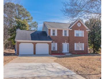 Charming two-story brick home with a two-car garage and well-maintained lawn at 5055 Promenade Sw Dr, Atlanta, GA 30331