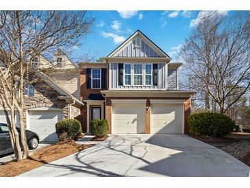 Charming townhome with a two-car garage and a mix of brick and gray siding at 5729 Evadale Trce # 6, Mableton, GA 30126