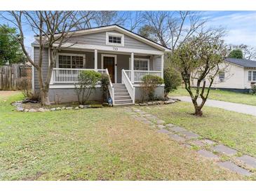 Charming bungalow-style home with inviting front porch and meticulously manicured landscaping at 733 Rice Nw St, Atlanta, GA 30318