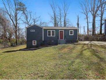 Charming single-story home with a well-maintained lawn and mature trees in a quiet neighborhood at 1406 Kennesaw Nw Dr, Atlanta, GA 30318