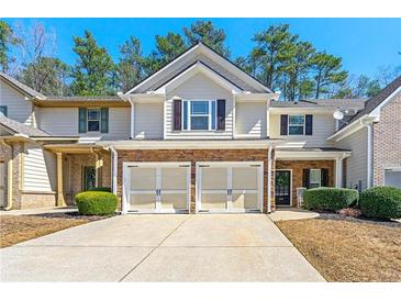 Inviting townhome featuring a two-car garage and charming curb appeal at 1119 Brownstone Dr, Marietta, GA 30008