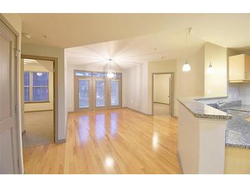 Bright living room features hardwood floors and access to an outdoor balcony at 390 17Th Nw St # 2024, Atlanta, GA 30363