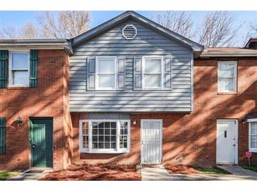 Charming townhome featuring a mix of brick and gray siding with a covered entry at 669 Hunting Creek Se Ln, Conyers, GA 30013