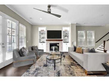 Bright living room with fireplace, built-in shelves, ceiling fan and lots of natural light at 108 Blakemore Se Dr, Smyrna, GA 30080