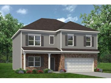 New two-story home showcasing brick and gray siding, complemented by a well-manicured lawn and lush landscaping at 525 Lanier Way, Temple, GA 30179